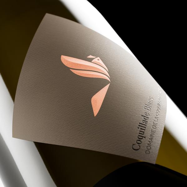 Bouteille de Coquillade Blanc, vin blanc du Domaine de la Coquillade, avec étiquette dorée et logo alouette